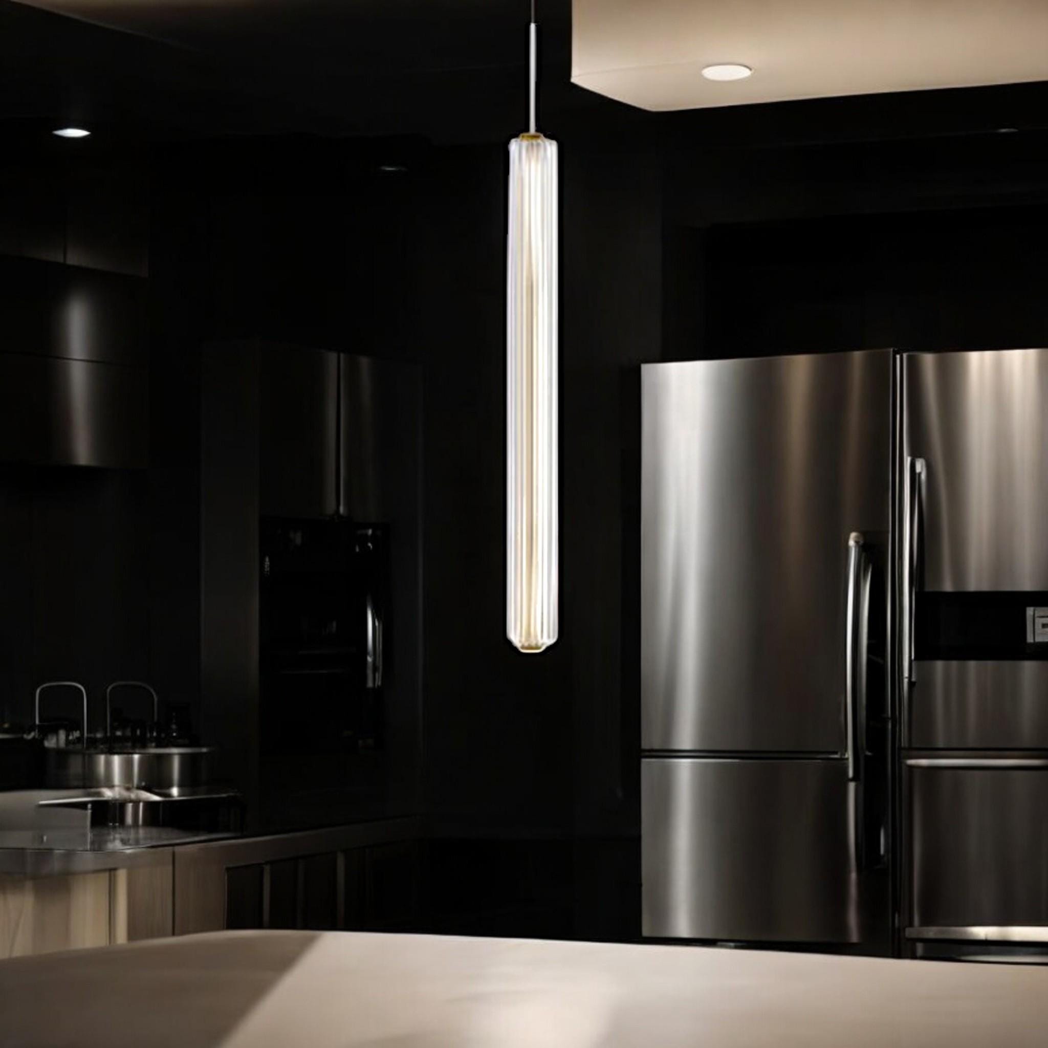Custom glass pendant light hanging in a modern kitchen with sleek appliances and dark cabinetry.