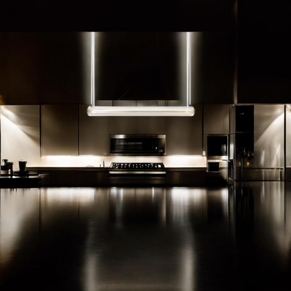 custom glass pendant light illuminating a modern kitchen with sleek cabinetry and dark countertops.